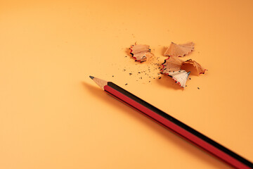 Pencil and sharpener with shavings, yellow pencils, and wooden office tools for drawing and writing...