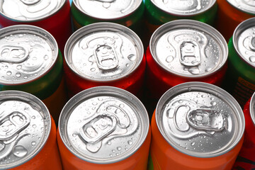 Energy drinks in wet cans, closeup. Functional beverage
