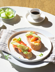 Breakfast in Scandinavian stylet: sandwiches with smoked salmon, cream cheese mousse and cucumber. Healthy natural quick recipes. Natural beautiful light	 - 768880762
