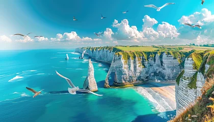 Fototapete Photo of Étretat in France, white rocks and green grassy hills on the left side, beach with blue water on the right side, flying seagulls, clear sky, sunny day © Kien