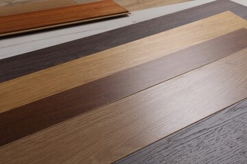 Different samples of wooden flooring as background, closeup - obrazy, fototapety, plakaty