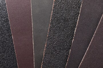 Fototapeta premium Many sheets of sandpaper as background, top view