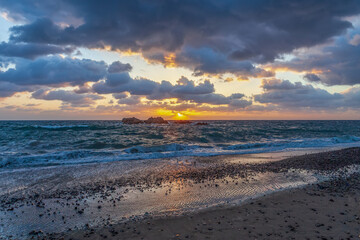The sunrise view of the Royal Tomb of King Munmu in Gyeongju, Gyeongsangbuk-do, Korea, with the sea and seagulls on a wavy winter morning.