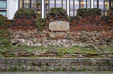 London, UK: Part of the ancient city wall of London. This is a medieval wall with the Roman fort wall at its base and topped with a brick parapet added in 1477. Landscape orientation.