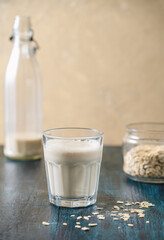 Glass of Milk with Bottle and Oats on Side