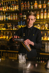 Bartender uses shaker for drinks background Ukrainian Trident. Skilled barkeeper makes refreshing cocktail for wealthy client