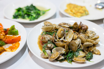 Taiwanese local food store with stir fry clam with basil