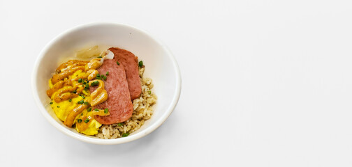 Filipino breakfast bowl with carmalized fired spam, topped with spice dijon mustard, rice and egg