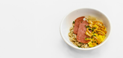 Filipino breakfast bowl with carmalized fired spam, topped with spice dijon mustard, rice and egg