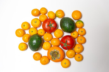 Assortment of fresh vegetables close-up. Green salad, tomato, avocado, tangerines, persimmon, for a...