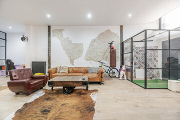 Large open space in a loft-style home with transparent partitions, decorative wood and metal furniture in an industrial style