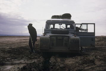 The old car is stuck in the mud
