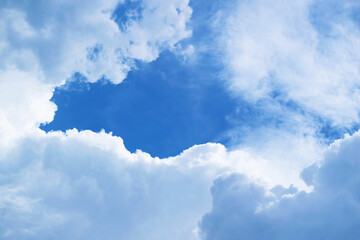 Naklejka na ściany i meble Fluffy White Clouds Forming an Amazing Frame on Vibrant Blue Sky