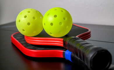 Pickleballs and Pickleball paddles. The sport of pickleball has become one of the fastest growing...
