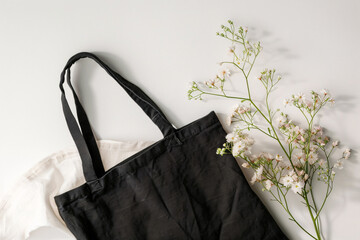 Mock-up scene of blank black tote bag with flowers - 768909166