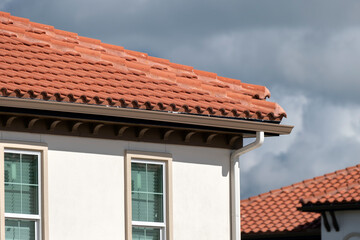 Tiled roof covering of condo building in Florida. Closeup of house rooftop covered with ceramic shingles