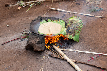Ethiopia, in a Dorze village preparation and cooking of traditional false banana flatbread.