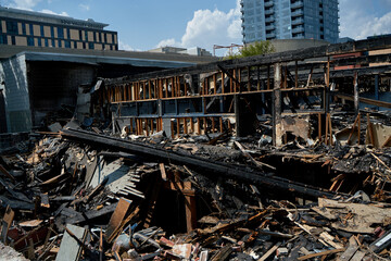 A burnt-out old wooden building after a fire. Charred beams after the destruction.
