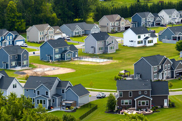 View from above of residential houses in living area in Rochester, NY. American dream homes as...