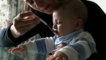 Parent feeding baby toddler infant boy son