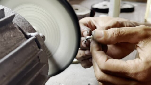 A master craftsman polishing a silver mirror