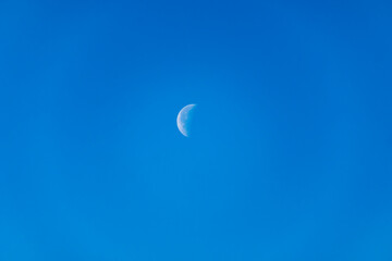 Waning Gibbous moon. A waning gibbous moon is a moon between full and last quarter, over blue sky