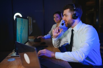 Center of dispatching maintenance. Portrait of cheerful woman and man working via headset...
