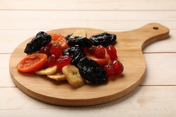 Mix of delicious dried fruits on white wooden table