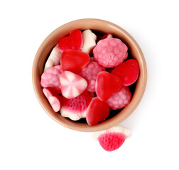 Tasty pink candies in bowl isolated on white, top view