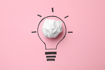Idea concept. Light bulb made with crumpled paper and drawing on pink background, top view