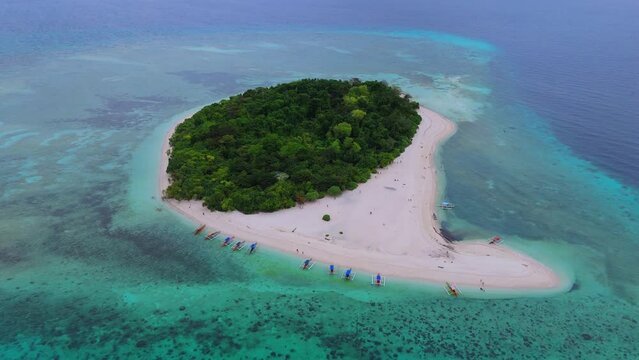 Drone shot orbiting right, capturing the picturesque colors of Mantigue Island in full view.