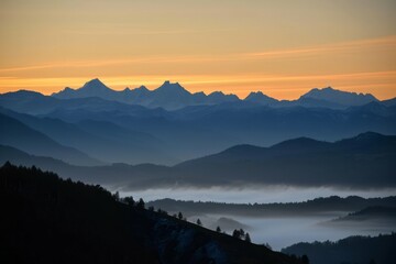 Serene sunrise over misty mountains with layered silhouettes and a gradient sky.