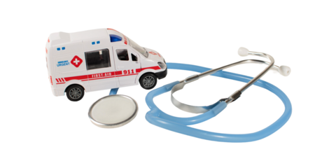 A toy ambulance and a stethoscope are on a table for emergency concept.