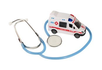 A toy ambulance and a stethoscope are on a table for emergency concept.