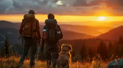 Fotobehang Man and dog on mountain, watching sunset in natural landscape © Gromik