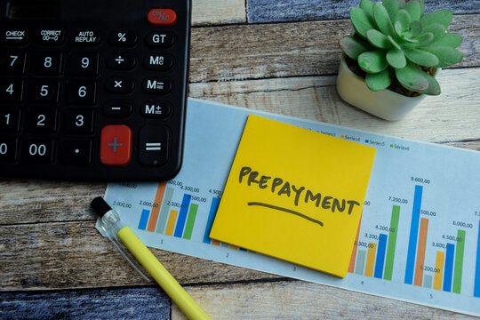 Concept of Prepayment write on sticky notes isolated on Wooden Table. stock market concept