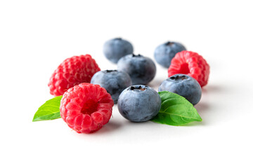 Sweet berries mix isolated on white background. Ripe raspberry and blueberry.