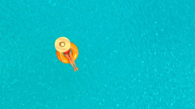 Young woman lies on the donut in the swimming pool top view 3D 4K animation. Copy space.
