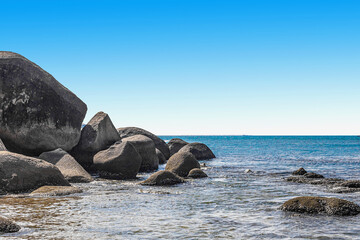 Huge rocks on the shore of the South China Sea in the World's End park. Sanya, China