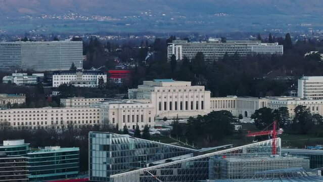 Aerial ascending footage of Palais des Nations, home of United Nations Office. Complex of buildings of international organization. Geneva, Switzerland
