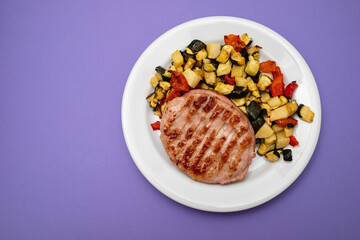 Delicious grilled chicken burgers served with baked vegetables