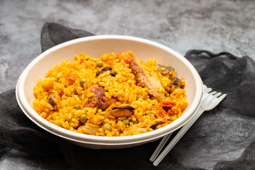 typicla spanish dish paella in plastic plate