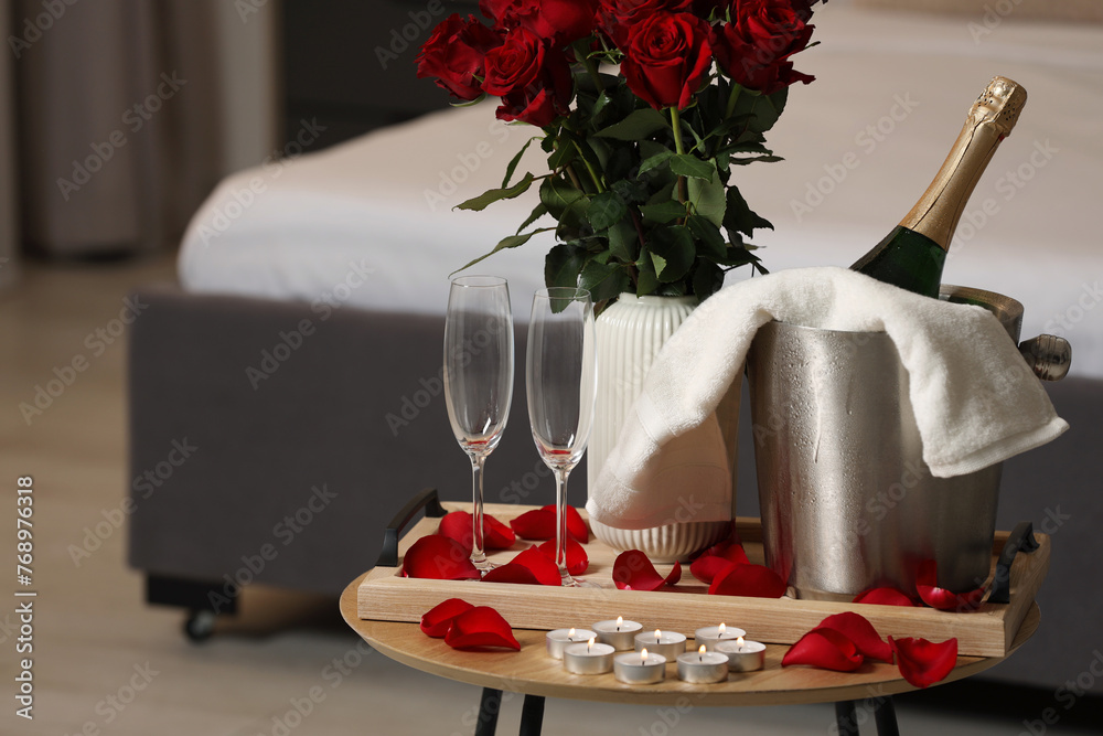 Canvas Prints Honeymoon. Sparkling wine, glasses and bouquet of roses on wooden table in room. Space for text