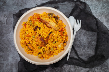 typicla spanish dish paella in plastic plate