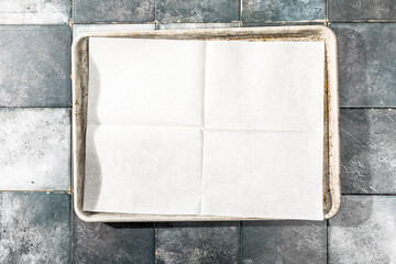 Overhead of folded parchment paper on tray