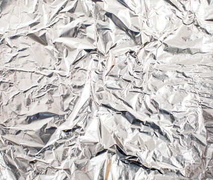 Overhead of crumpled tin foil - Powered by Adobe