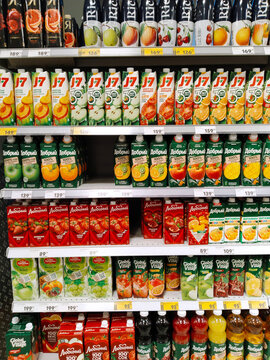 Supermarket shelves with various packs of fruit juice: J7, Rich, Kind. Food. Retail industry. Grocery shopping. Store. Consumer trends analysis concept. CPG. St. Petersburg, Russia - January 31, 2024