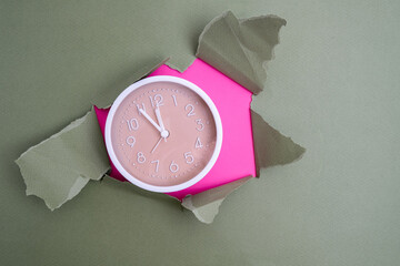 White alarm clock on a colored background. Fashionable minimalist style. Time, business and technology concept. Flat composition. View from above
