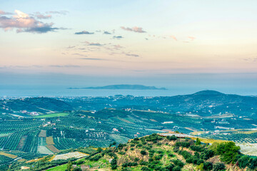 Beautiful view of landscape with olive trees and mountains on Crete island during sunset.