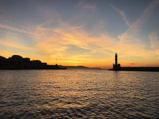 Lighthouse in the Old Venetian Harbour in Chania during sunset. Crete. Greece.